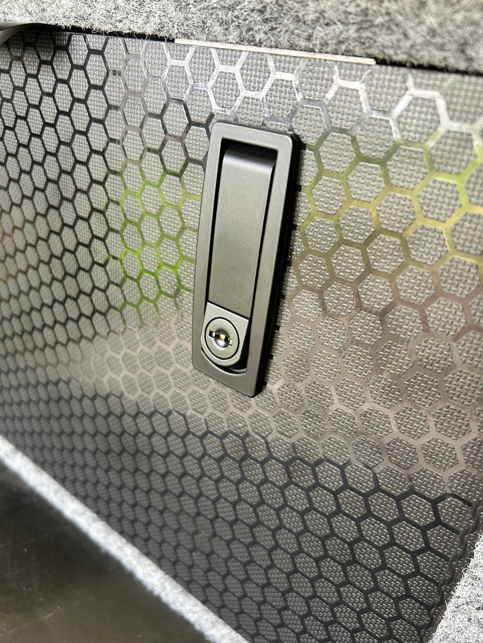 Honeycomb drawer locking latch close-up — premium 4WD drawer system hardware by TAWL