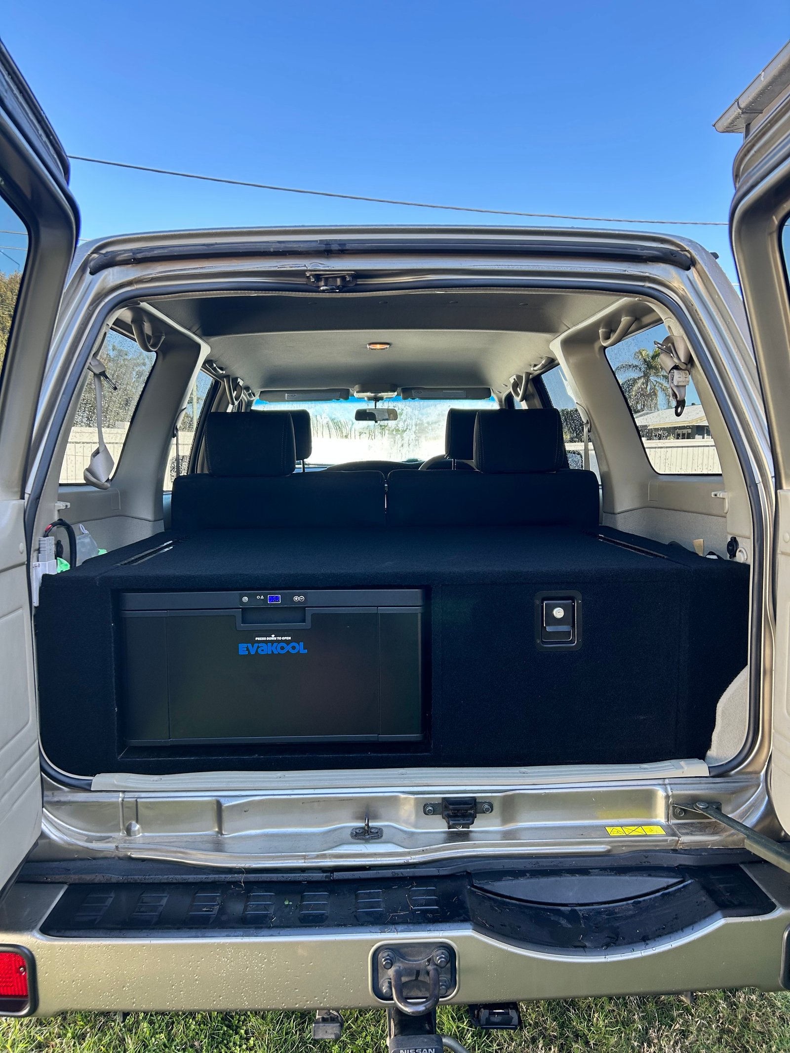 Nissan Patrol carpeted drawer system with integrated EvaKool fridge — full-width black cargo install by TAWL